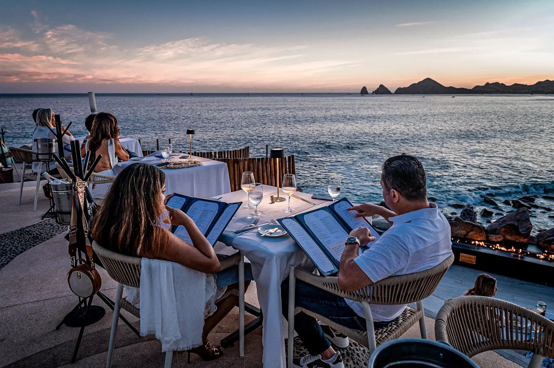 people having a dinner at sunset Monalisa ocean view with sunset at the background to the pacific ocean.